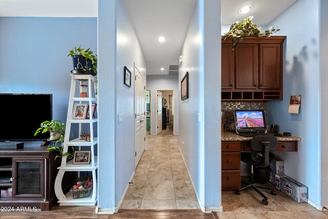 hall featuring baseboards and recessed lighting