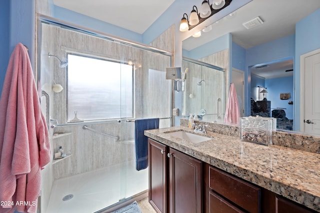 bathroom with visible vents, a stall shower, vanity, and a healthy amount of sunlight