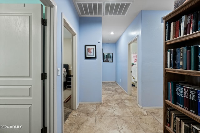 hallway with visible vents and baseboards