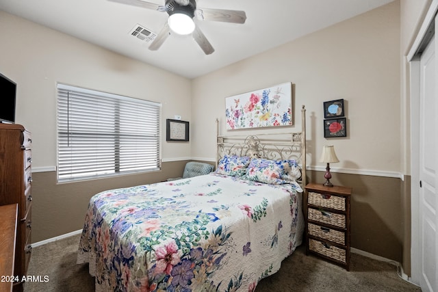 bedroom with baseboards, carpet flooring, visible vents, and a ceiling fan