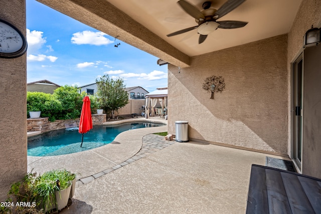 view of swimming pool featuring a fenced in pool, a gazebo, a patio area, ceiling fan, and a fenced backyard