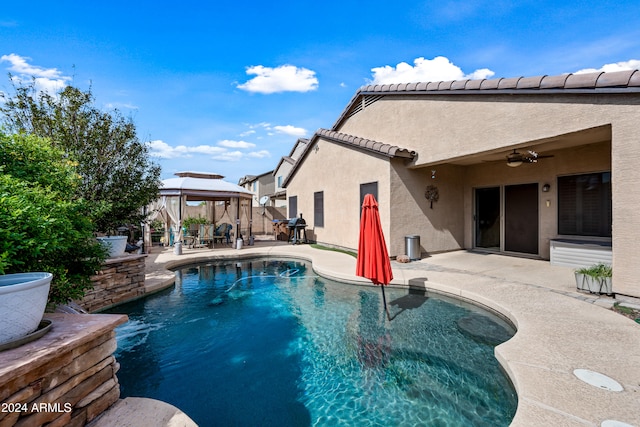 pool with a patio, a gazebo, and ceiling fan