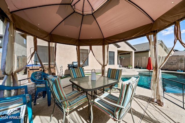 view of patio / terrace with a fenced in pool, outdoor dining area, and fence