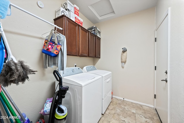 laundry area with attic access, washing machine and dryer, cabinet space, and baseboards