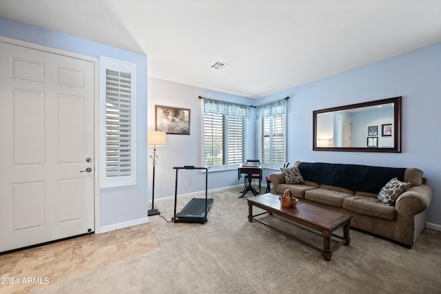 living room featuring carpet floors, visible vents, and baseboards