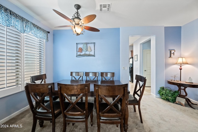 carpeted dining area with ceiling fan, visible vents, and baseboards