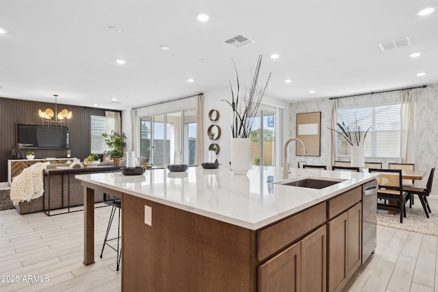 7333 W Buckhorn Trl, Peoria, AZ 85383 - kitchen featuring a sink, light wood-style floors, a spacious island, a chandelier, and recessed lighting