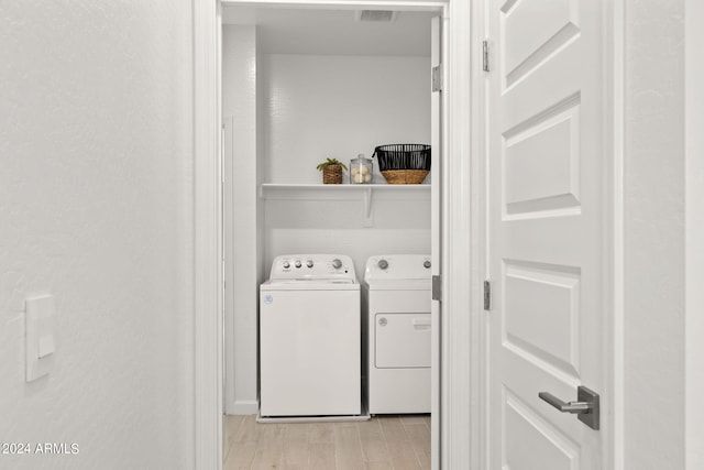 7333 W Buckhorn Trl, Peoria, AZ 85383 - laundry room with washer and clothes dryer and light wood-type flooring