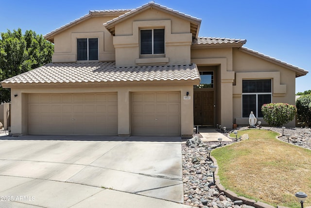 5957 W Robin Ln, Glendale, AZ 85310 - mediterranean / spanish-style home featuring stucco siding, driveway, and a tile roof