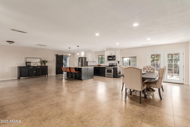 tiled dining room featuring french doors