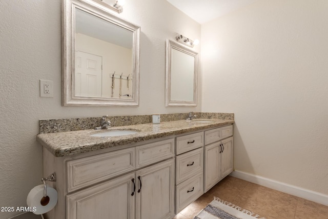 bathroom featuring tile patterned flooring and vanity