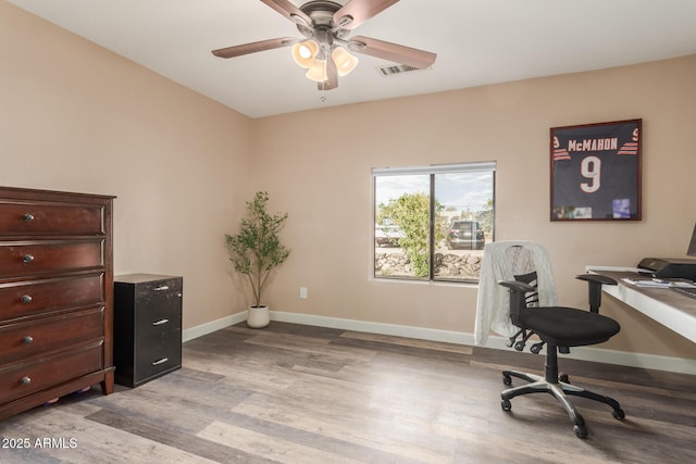 home office featuring light wood-type flooring and ceiling fan