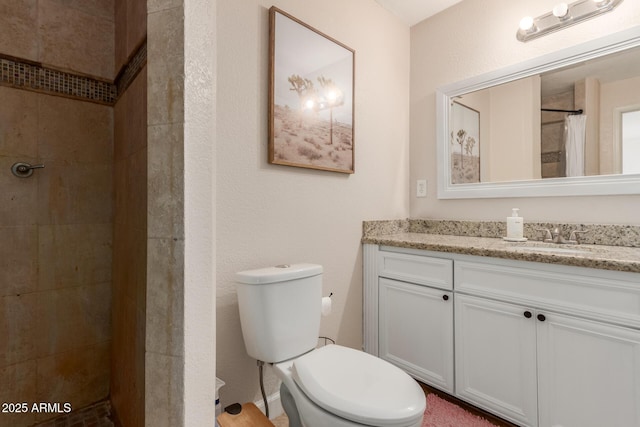 bathroom featuring toilet, a shower with shower curtain, and vanity