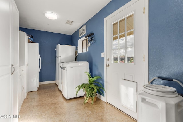 washroom featuring light tile patterned floors and washer / dryer