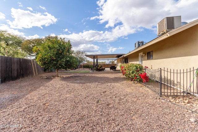 view of yard featuring central AC and a patio area