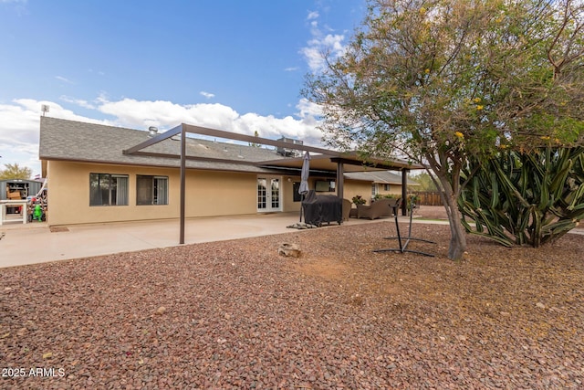 back of property with a patio area and french doors