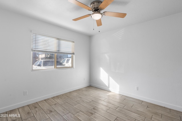 empty room with light wood-type flooring, baseboards, and a ceiling fan