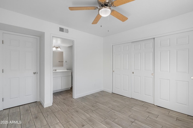 unfurnished bedroom featuring wood finish floors, a ceiling fan, visible vents, baseboards, and a closet