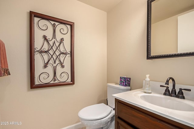 bathroom with toilet and vanity