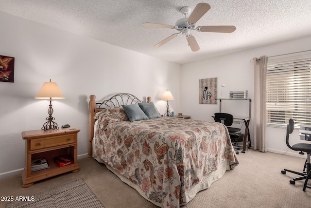 bedroom featuring ceiling fan, baseboards, a textured ceiling, and carpet flooring