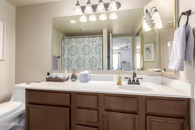 full bath with visible vents, vanity, and toilet