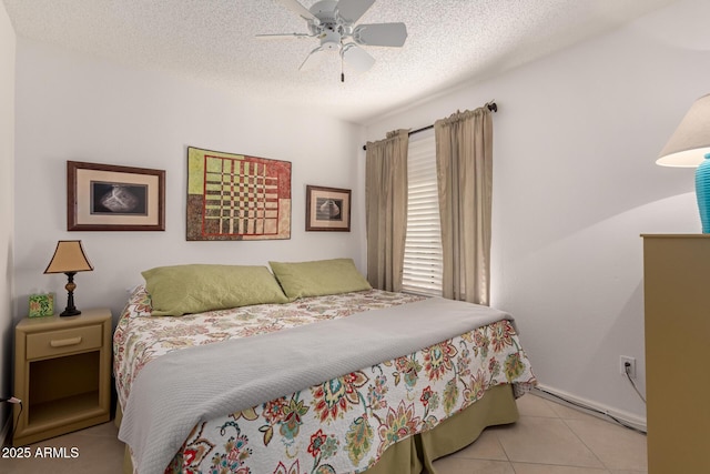 bedroom with a textured ceiling, ceiling fan, and light tile patterned floors