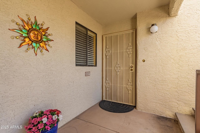 property entrance with stucco siding