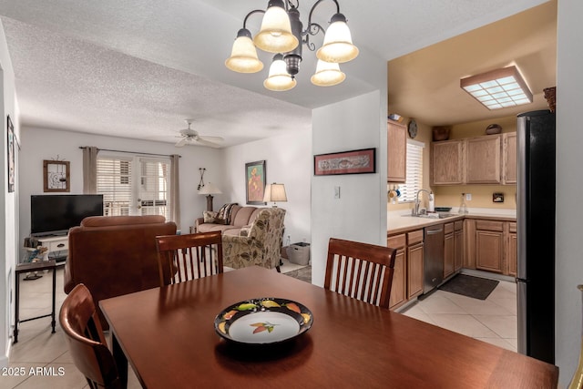 dining space featuring light tile patterned floors, a textured ceiling, and ceiling fan with notable chandelier