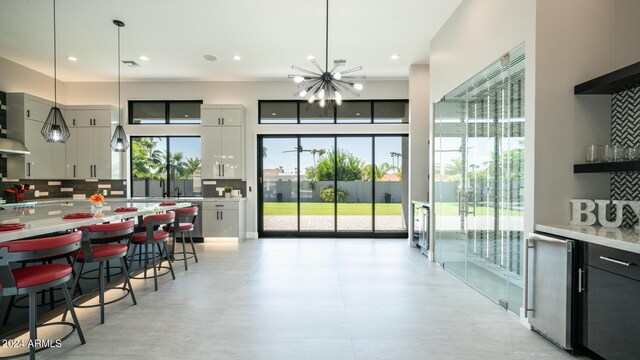 kitchen with pendant lighting, stainless steel appliances, a center island, and plenty of natural light