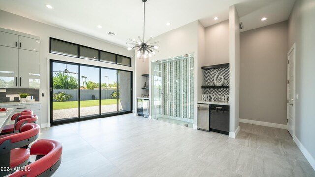 kitchen with a healthy amount of sunlight, high end stainless steel range oven, white cabinetry, and sink