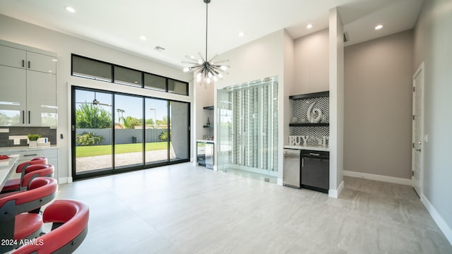 interior space with a towering ceiling and a chandelier