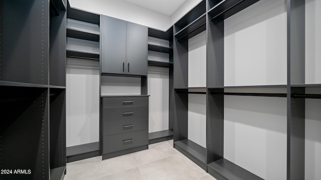 spacious closet featuring light tile patterned floors