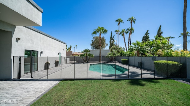 view of swimming pool featuring a lawn and a patio area