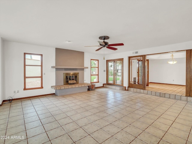 unfurnished living room featuring ceiling fan and light tile floors