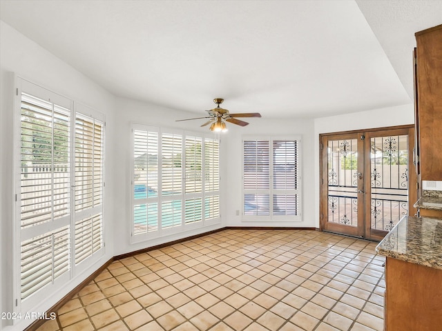 interior space featuring ceiling fan and french doors