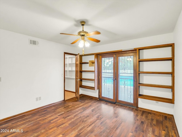 spare room with ceiling fan, dark wood-type flooring, and french doors