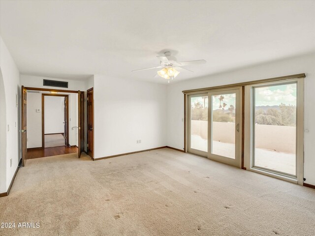 unfurnished room featuring light colored carpet and ceiling fan