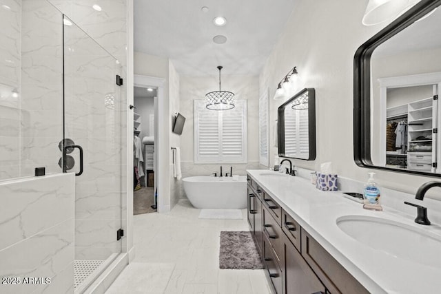 bathroom with double vanity, a freestanding bath, a sink, marble finish floor, and a marble finish shower