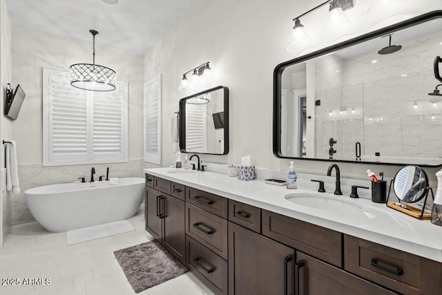 full bathroom featuring double vanity, a marble finish shower, a sink, and marble finish floor