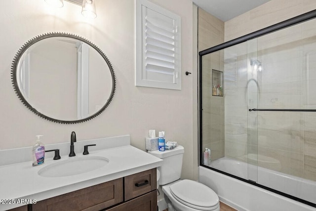full bathroom with toilet, combined bath / shower with glass door, and vanity