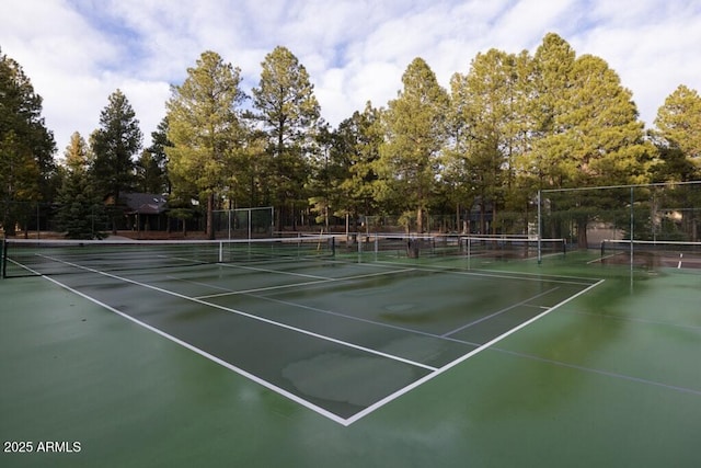 view of tennis court with fence