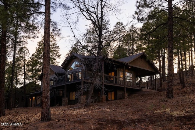 back of house featuring a wooden deck