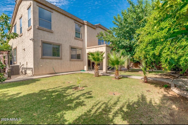 4151 E Campbell Ave, Gilbert, AZ 85234 - back of house with a lawn, central AC, and stucco siding