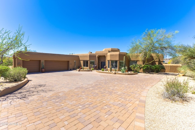 30600 N Pima Rd N Unit 81, Scottsdale, AZ 85266 - southwest-style home featuring stucco siding, decorative driveway, a garage, and fence