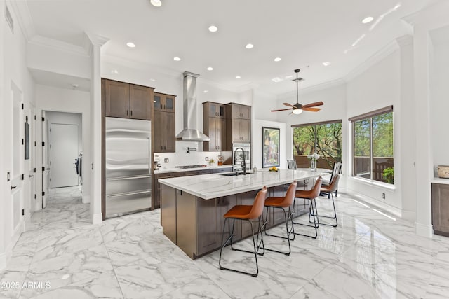 30600 N Pima Rd N Unit 81, Scottsdale, AZ 85266 - kitchen with built in refrigerator, wall chimney exhaust hood, crown molding, light marble finish flooring, and a ceiling fan