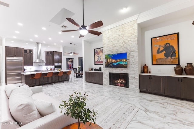 30600 N Pima Rd N Unit 81, Scottsdale, AZ 85266 - living area featuring a ceiling fan, light marble finish floors, recessed lighting, a fireplace, and crown molding