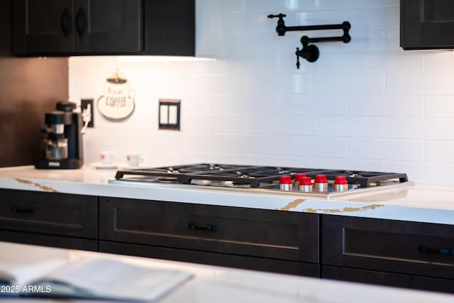 30600 N Pima Rd N Unit 81, Scottsdale, AZ 85266 - kitchen featuring light countertops, tasteful backsplash, dark cabinetry, and stainless steel gas cooktop