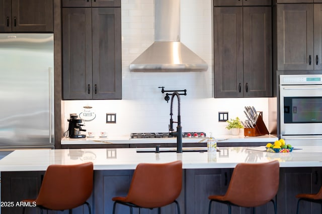 30600 N Pima Rd N Unit 81, Scottsdale, AZ 85266 - kitchen with white oven, stainless steel built in fridge, wall chimney range hood, dark brown cabinetry, and light countertops