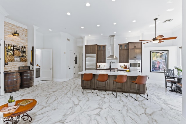 30600 N Pima Rd N Unit 81, Scottsdale, AZ 85266 - kitchen with wall chimney exhaust hood, stainless steel built in fridge, crown molding, light countertops, and a kitchen breakfast bar