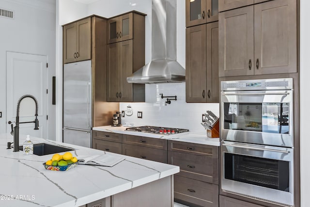 30600 N Pima Rd N Unit 81, Scottsdale, AZ 85266 - kitchen with stainless steel appliances, a sink, wall chimney exhaust hood, glass insert cabinets, and ornamental molding